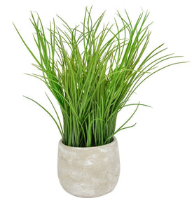 Artificial potted grass plant in grey pot