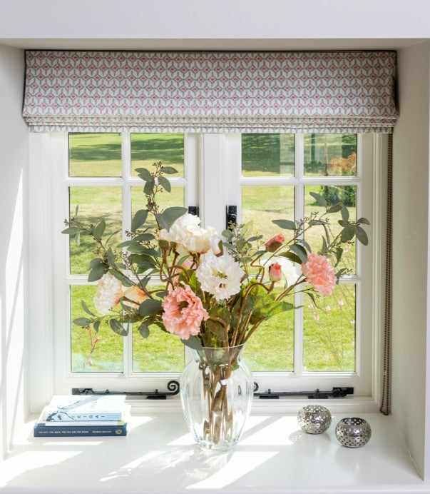 Artificial flower arrangement in vase with faux poppy and eucalyptus stems