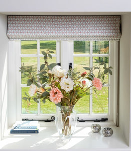 Artificial flower arrangement in vase with faux poppy and eucalyptus stems